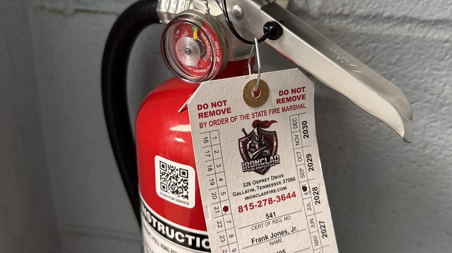 Fire safety technician inspecting commercial fire extinguisher