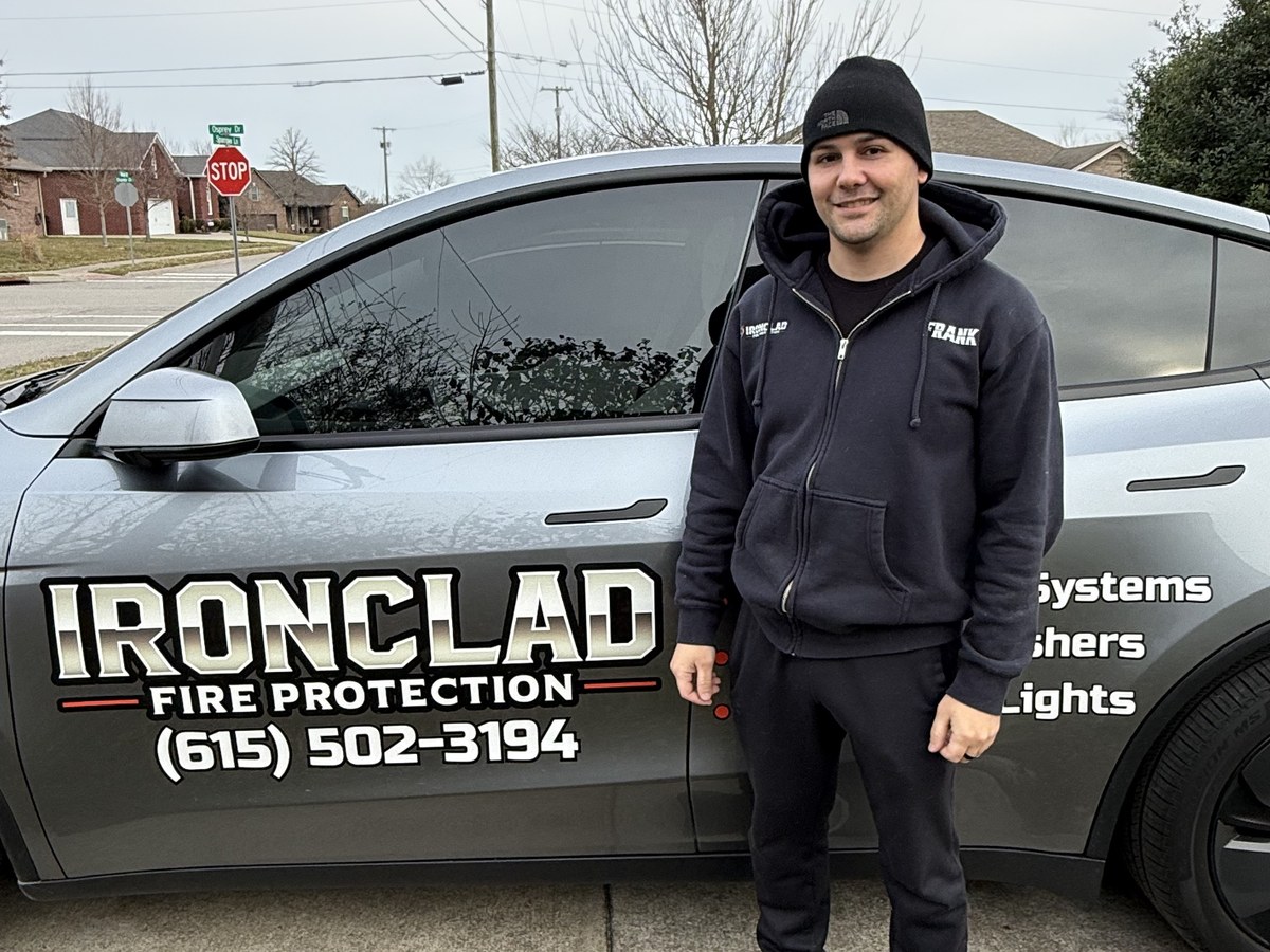 Frank Jones beside the Ironclad Fire Protection car